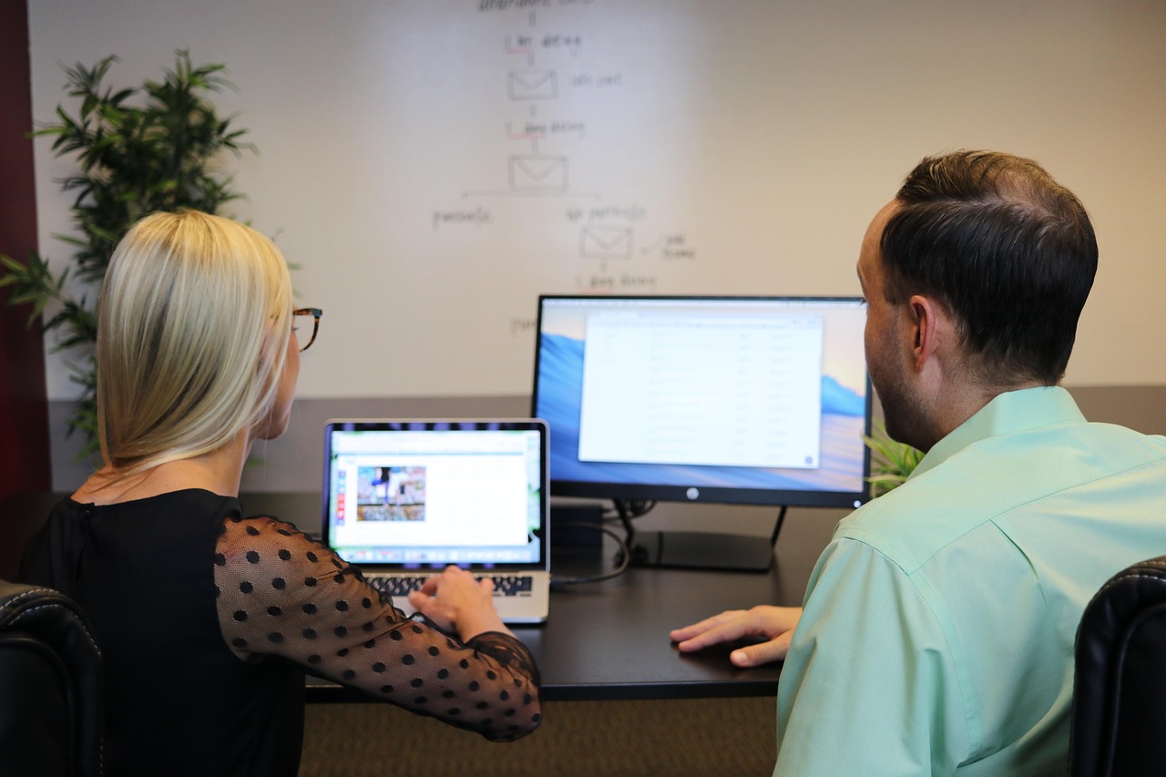 Business meeting reviewing analytics dashboard
